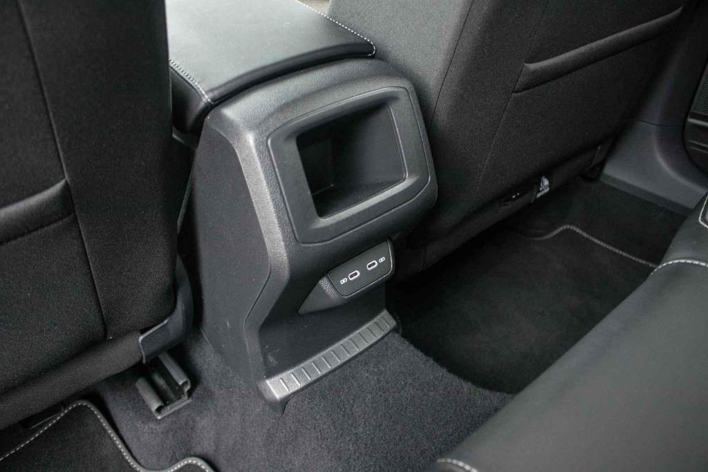 Vzadu nechybí nabíjeci USB sloty a úložná přihrádka.
